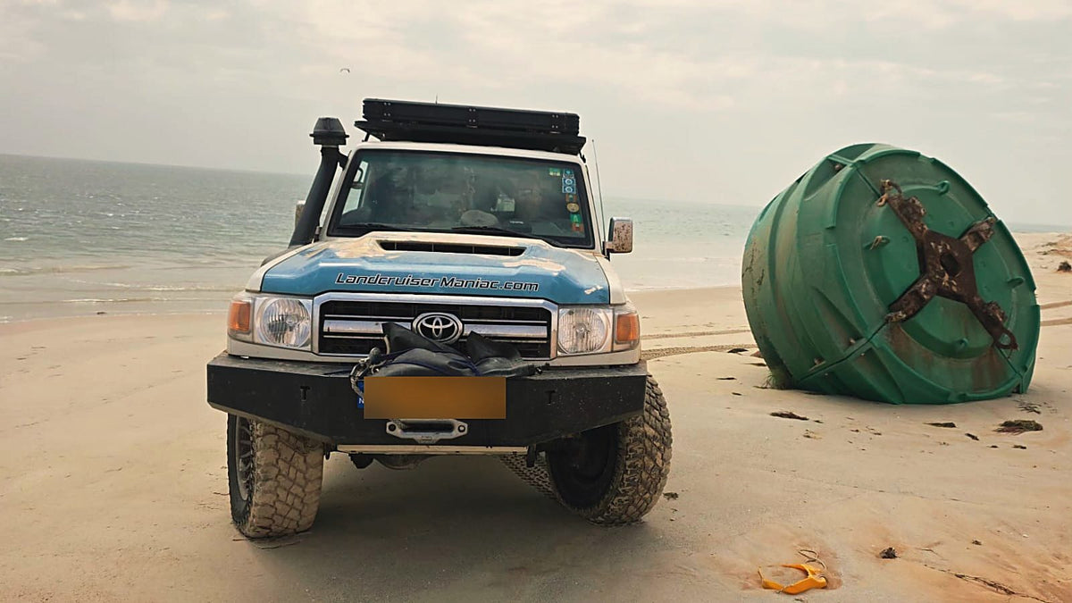 Land Cruiser on the coast beside a buoy, front view
