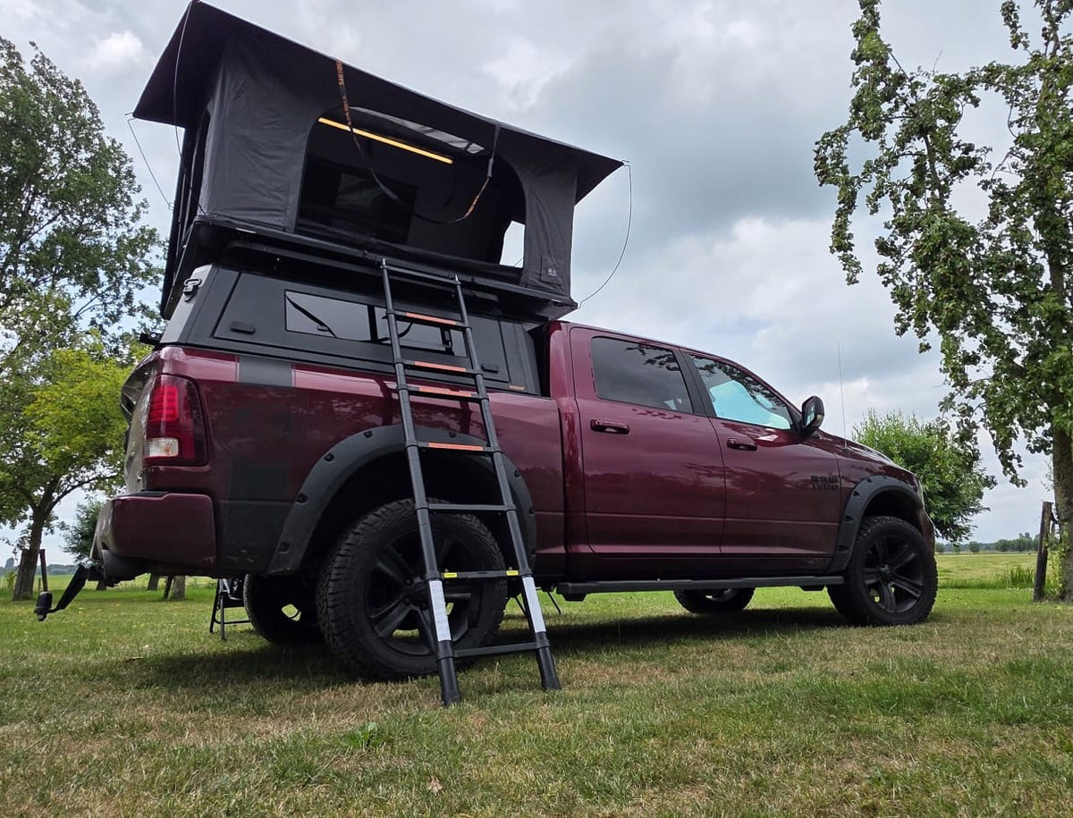 LCM Offroad Oasis hardshell rooftop tent open on a RAM pick-up, with telescopic ladder