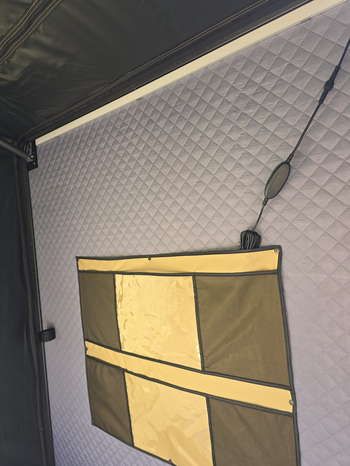 Storage organiser on the quilted inner wall of the LCM Offroad Savannah hardshell rooftop tent